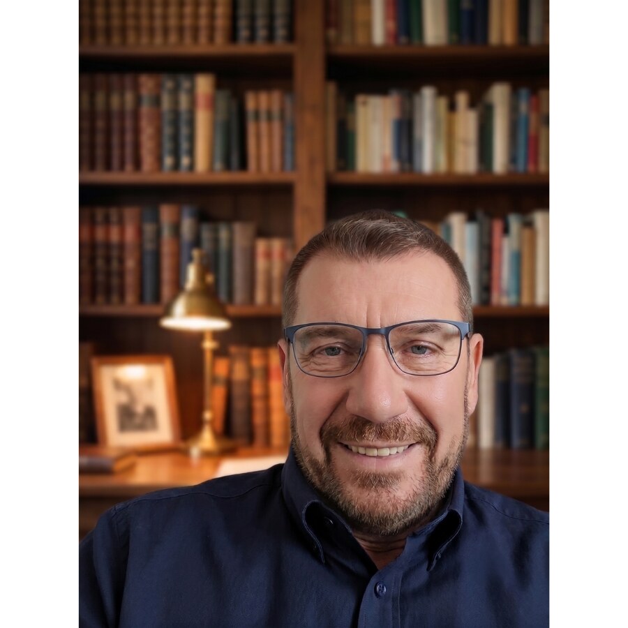 Alex Herek, founder of Alex Herek publishing, in his home library